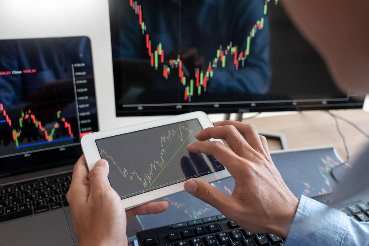 Inversionista estudia gráficos de velas para elegir cómo invertir en bolsa de valores Perú.