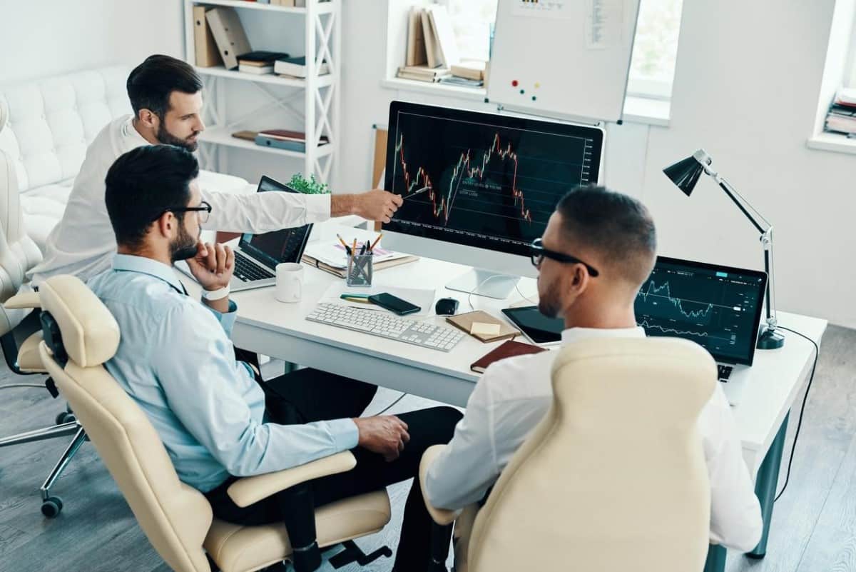 Compañeros de trading revisan gráficas proporcionadas por brókers de México.