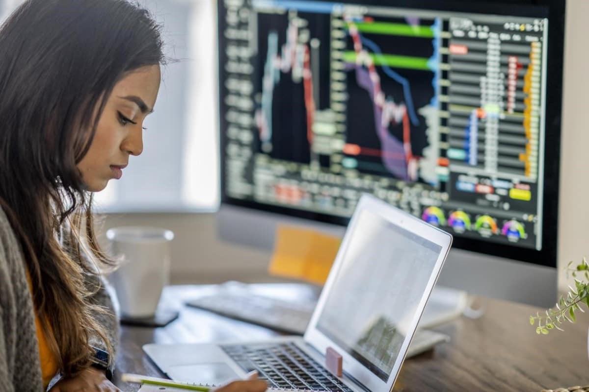 Una trader analiza en sus computadoras gráficos para invertir en bonos.