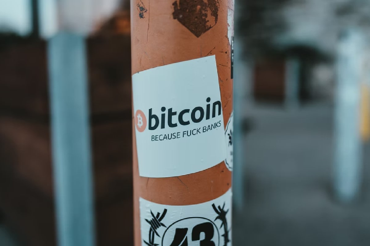 Papel pegado en un poste en la vía pública publicitando el Bitcoin 