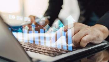  Un empresario revisa en su laptop gráficos sobre inversiones en Perú.